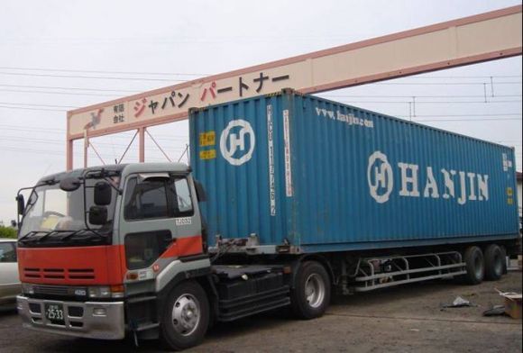 Imported car arriving by delivery truck